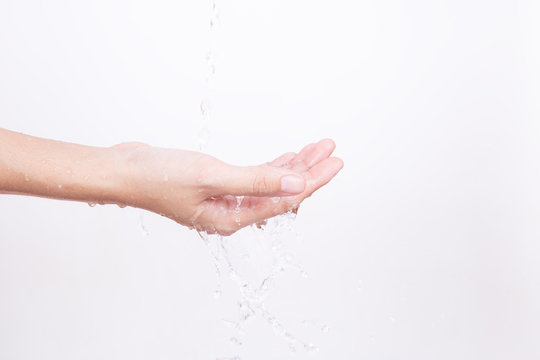The Asian girl's hands are splashed with water on white background