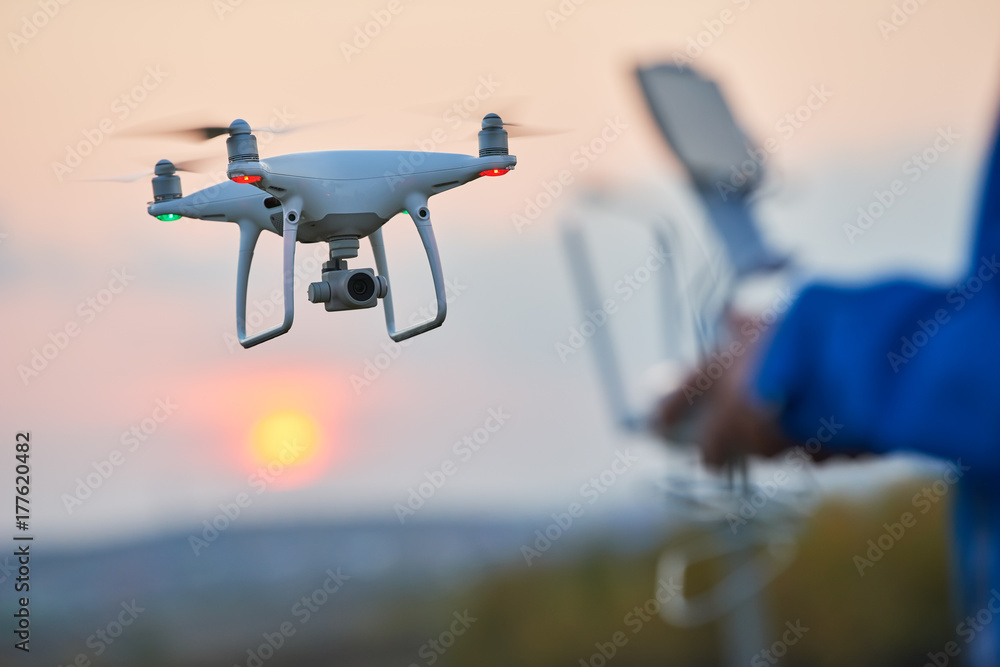 Wall mural drone flying and operated by remote controlsunset