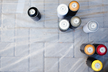 Close-up of cylinders bank with paint stand in a row. The concept of graffiti. View top