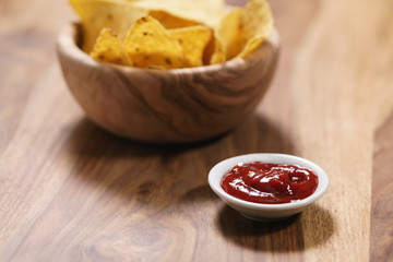 dip sauce and nachos on table