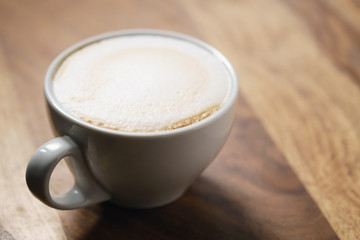 fresh flat white coffee on wood table