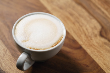 fresh cappuccino with chocolate flakes on wood table