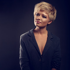 Beautiful smiling sexy woman with short bob blond hairstyle in suit on grey background. Closeup toned portrait © Anastasia.photoyoga