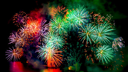 Colored fireworks display on dark sky background.