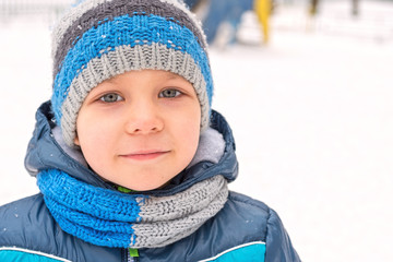 Adorable little boy in winter park