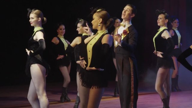 A stage show at a cabaret features dancers and singers