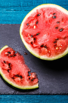 Image of cut watermelon in blue table