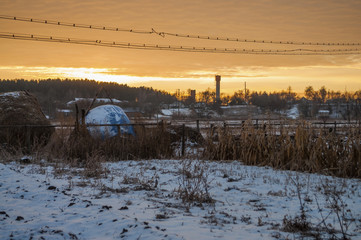 Fototapeta na wymiar Beautiful morning and winter bright sunrise in January. Suburb and field covered snow