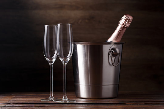 Photo of two empty wine glasses, iron bucket