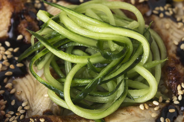 Fish fillets with sliced cucumbers.