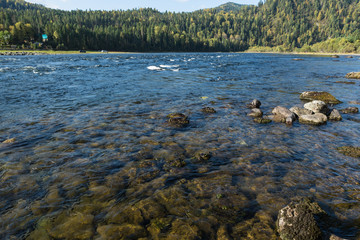Small hidden waterfall in the forest in the cleft of the rock