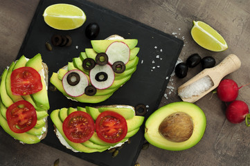 Healthy breakfast, avocado bread, olives, radish and tomatoes slices