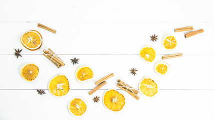 ingredients of spices and oranges for mulled wine on a white wooden table. background. copyspace