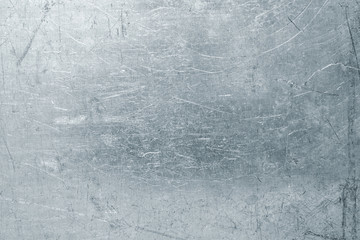 Worn steel sheet background, light metal texture with scratches and dents