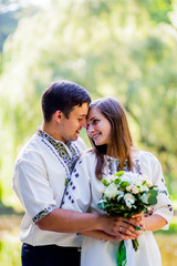 Amazing couple in clothes with embroidery hugs