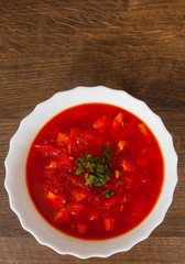 Bowl of red beetroot soup on a wooden background. with copy space. top view