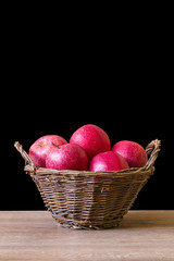 Red apples in a wicker basket