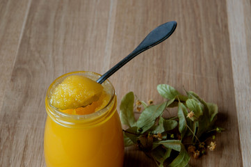 linden honey on a wooden table