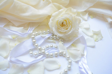 Fototapeta na wymiar wedding congratulation on a background from white roses and delicate pearl beads