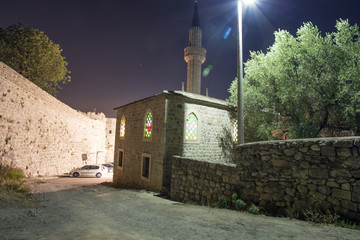 evening view of the old church near the high wall.