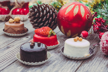 An array of Christmas desserts with colorful   , on wooden board