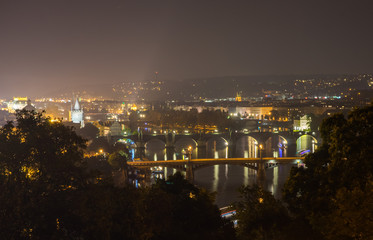 Fototapeta na wymiar Bridges of Prague at night. View of the bridges from the Leten gardens. Czech Republic
