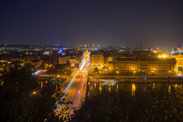 Fototapeta premium Night Prague. View from the Leten gardens. Light trails from cars. Shtefanikov Bridge