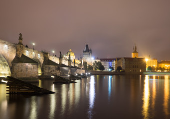 Fototapeta na wymiar Charles in Prague, Czech Republic. Light of lanterns reflected in the Vltava River
