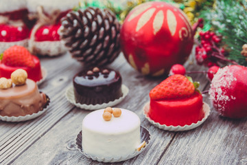 An array of Christmas desserts with colorful   , on wooden board
