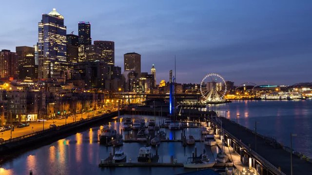 Time lapse video of a colorful and vibrant sunrise overlooking the Pier and Ferris Wheel in Downtown Seattle, Washington, United States of America.
