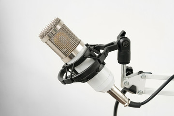 Professional condenser studio microphone on the white background