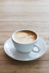 Coffee in a cup on a wooden table