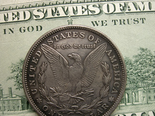 In God we trust on banknote and Morgan dollar coin - obrazy, fototapety, plakaty