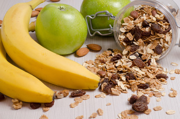 Healthy Breakfast. Granola, apples, bananas, oatmeal with raisins, honey, nuts. Measuring tape