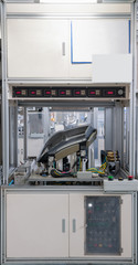 testing automobile headlights for leaks. factory equipment of quality control of car headlamps