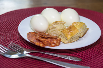 boiled eggs, dough and sausages