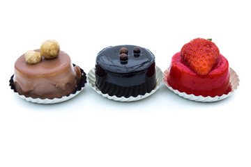 Mixed dessert - sweet pie with hazelnuts, chocolate and strawberry, isolated on white background