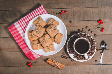 Black coffee in a white cup on a red napkin and homemade cookies.