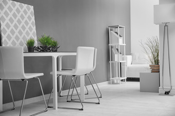 Modern room interior with white chairs and table