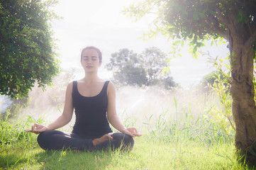 Young woman practicing yoga Everyday Yoga helps in concentration, meditation,breath, shape, strength, help skin brighten. Among the Dharma Air in bright days