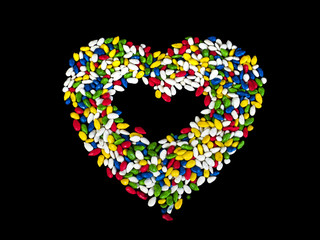 Sweets in heart shaped. Sunflower seeds in color glaze. Вlack background