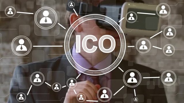 Businessman presses currencies button ICO Initial Coin Offering on virtual digital online electronic user interface.