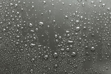 Metal surface with drops of water, silvery background