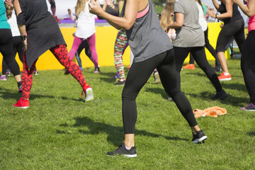 Group of young girls exercising fitness with dancing in the city park