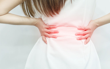 A woman in white dress feeling pain on his back. Office syndrome. Back pain from work. Herniated nucleus pulposus. spine pain. spinal degeneration.