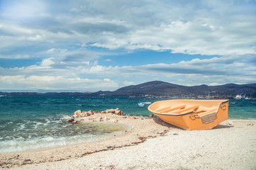 Fototapeta na wymiar Empty boat on stony beach in croatia