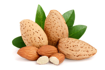Group of almond nuts with leaves isolated on white background