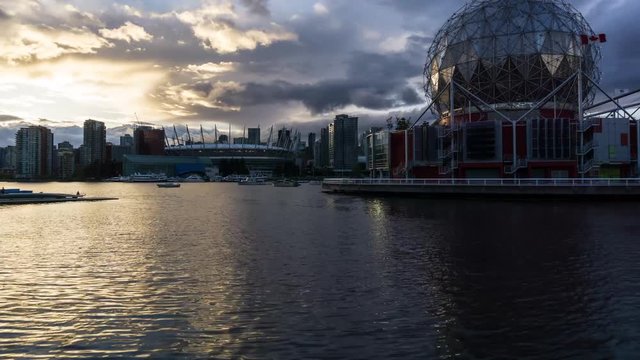 Time lapse video of a colorful and vibrant sunset with rain clouds passing by the Downtown City. Taken in False Creek, Vancouver, British Columbia, Canada.
