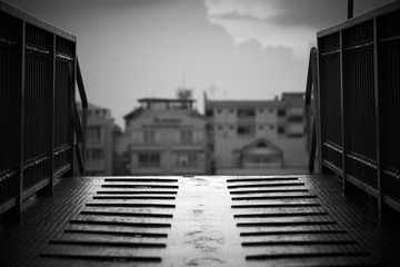 Obraz premium The walkway connecting the building. Made from steel plate with slippery. black and white tone. copy space.