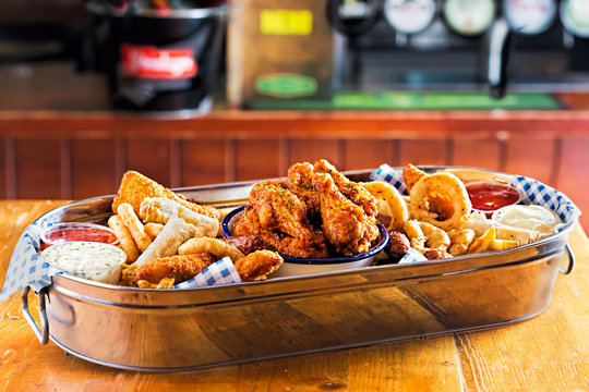 Platter with chicken goujons, crispy chook wings, cocktail sausages, veg spring rolls, onion rings & fries served with dips
